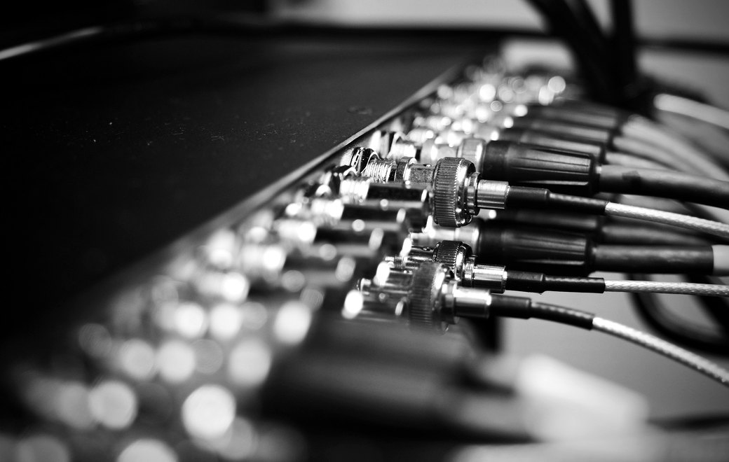 A dense row of chrome signal connectors receding into shallow focus